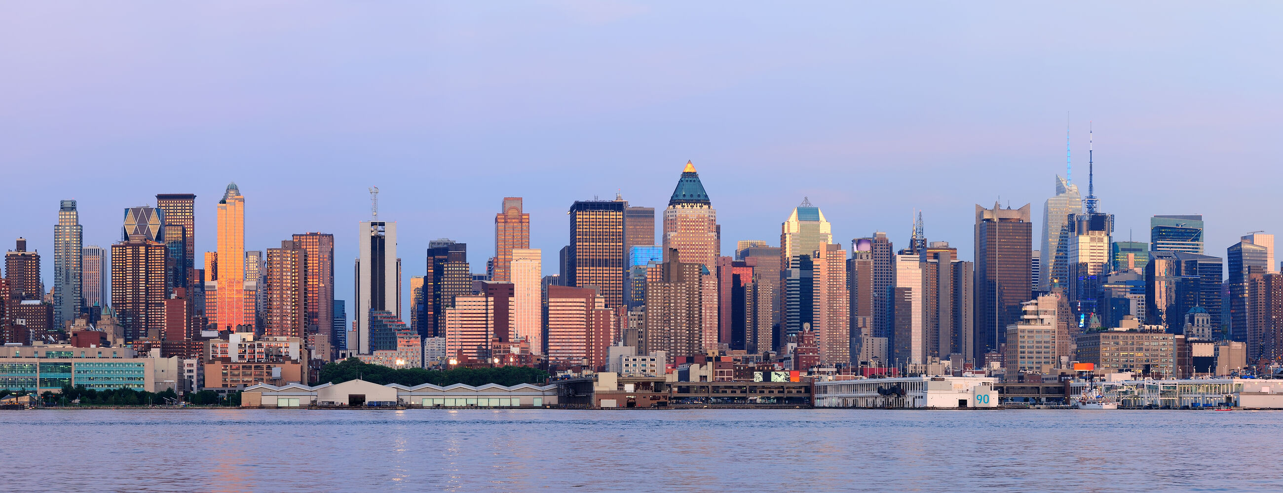 Midtown Manhattan skyline at dusk over the Hudson River
